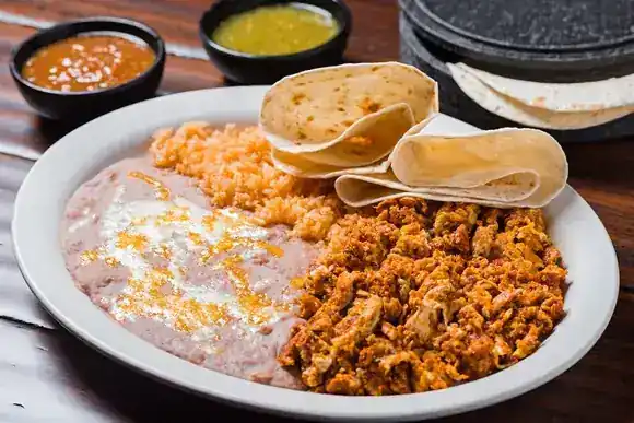 A Mi Casa combination plate with a chile relleno, rice and corn salad