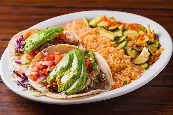 Three tacos on a Mi Casa plate
