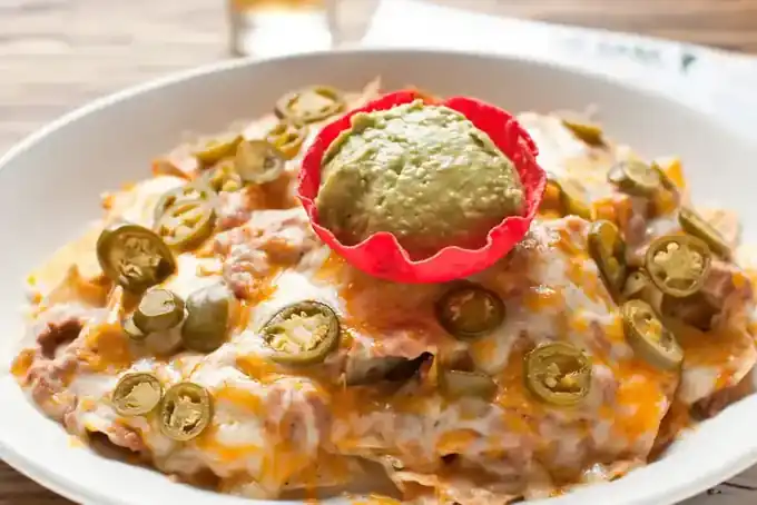 A platter of Mi Casa nachos with beans, cheese, jalapeño and guacamole
