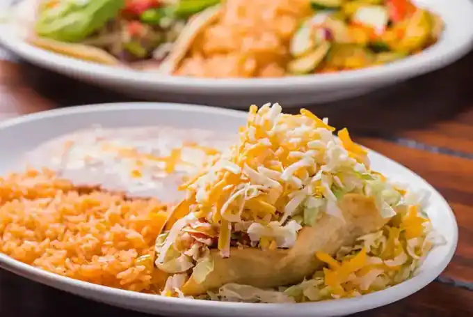 Tacos, chips and salsas spread across a table